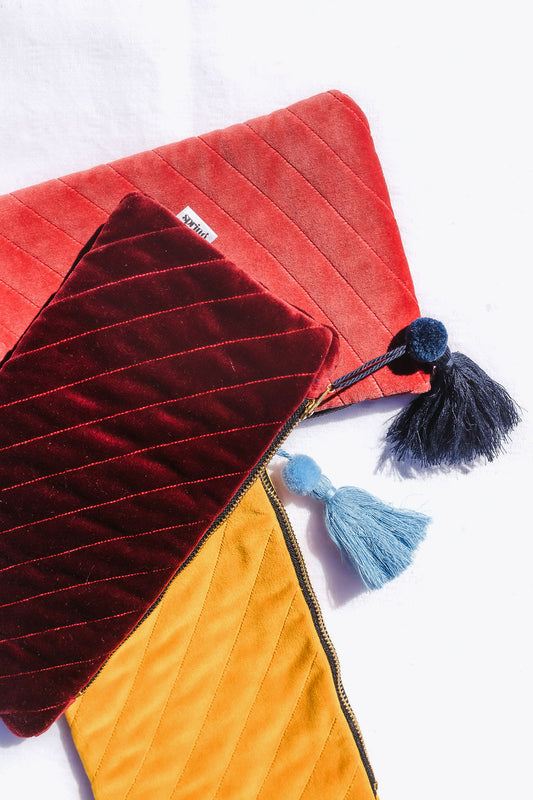 yellow clutch with blue tassel