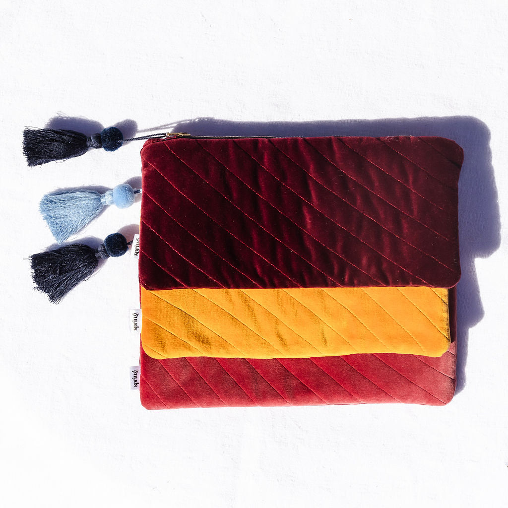red clutch with navy tassel