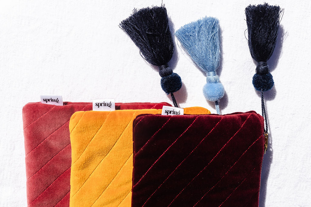 red clutch with navy tassel