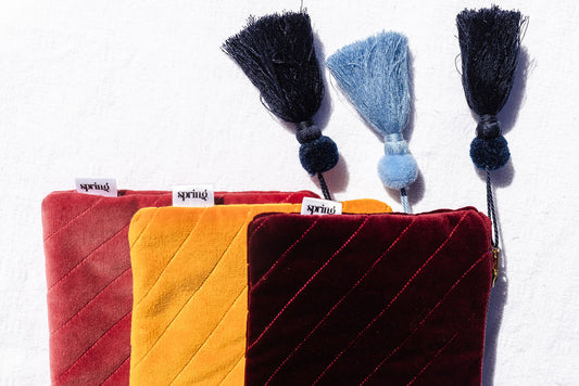 red clutch with navy tassel