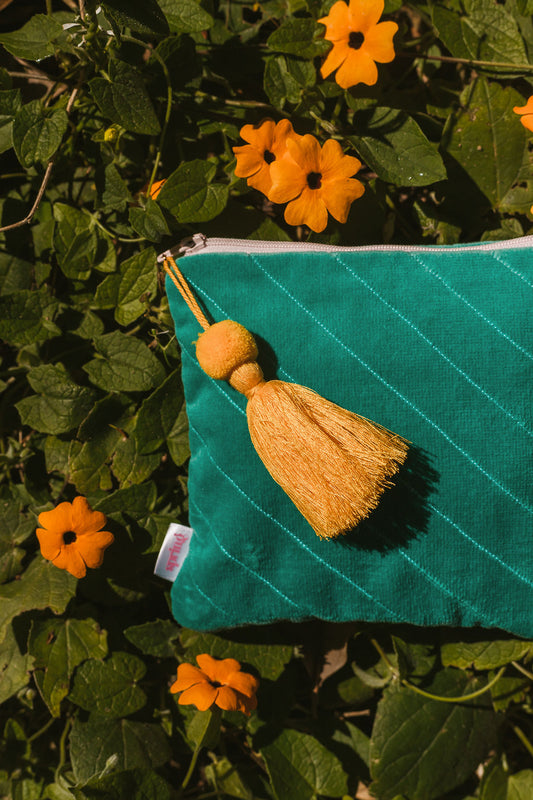 turquoise clutch with yellow tassel